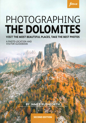 Front cover image of book, showing jagged mountain peak with woodland foreground and pale blue sky above